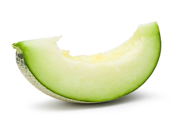 istock Ripe green melon slice isolated on white with clipping path. 1203093345