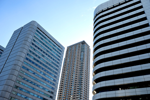 Low angle view of abstract modern office buildings against clear sky with copy space.