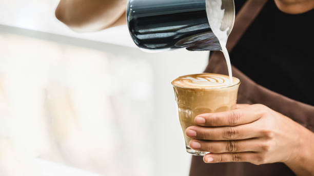 Professional barista making latte art coffee stock photo