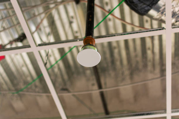 Concealed fire sprinkler heads above ceilings with cover plates during construction or maintenance.