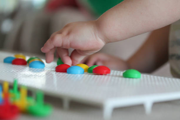 istock Child playing with pegboard mushroom nail mosaic 1203106438