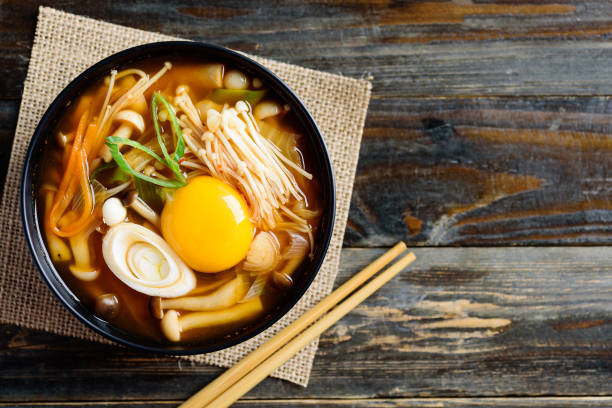 istock Kimchi soup with mushroom and egg yolk in a bowl 1203106495