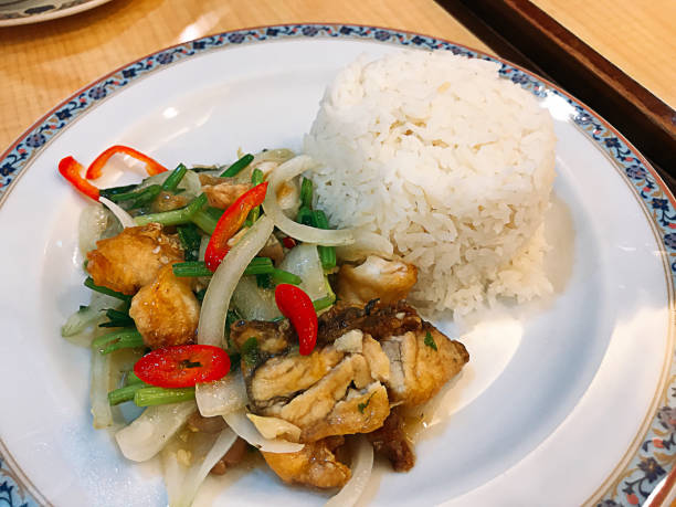 Rice served with stir fried snapper fish with fresh chilies in Thailand.