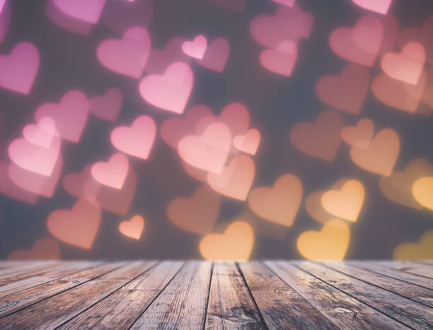 istock Valentine's day background, table over heart shape bokeh 1203108901
