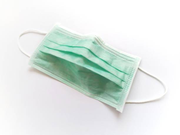 istock Medical green protective mask isolated on white background. 1203109757
