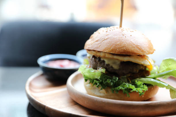 istock Beef hamburger with cheese green salad egg and sauce in restaurant 1203112714