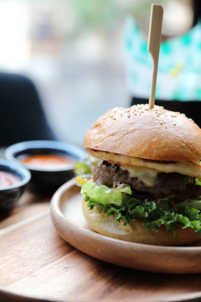 istock Beef hamburger with cheese green salad egg and sauce in restaurant 1203112879