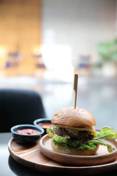 istock Beef hamburger with cheese green salad egg and sauce in restaurant 1203112906