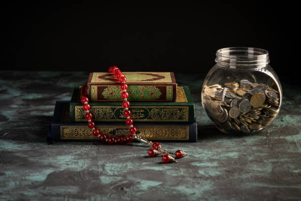 istock Islamic concept: The holy Quran and Tasbih (prayer beads beads) on dark background 1203115629