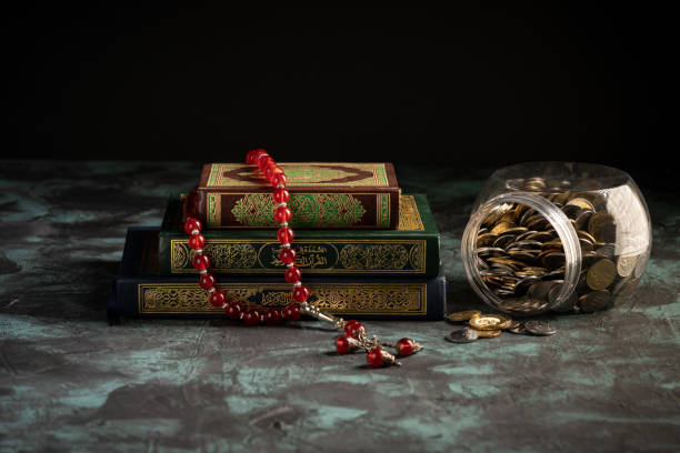 Islamic concept: The holy Quran and Tasbih (prayer beads beads) on dark background
