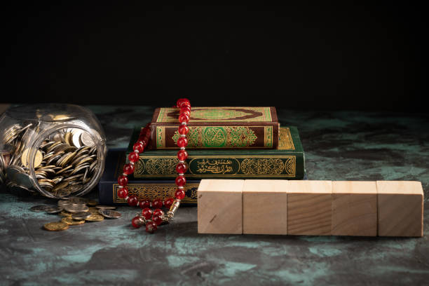 Islamic concept: The holy Quran and Tasbih (prayer beads beads) on dark background Islamic concept: The holy Quran and Tasbih (prayer beads beads) on dark background kaabah stock pictures, royalty-free photos & images
