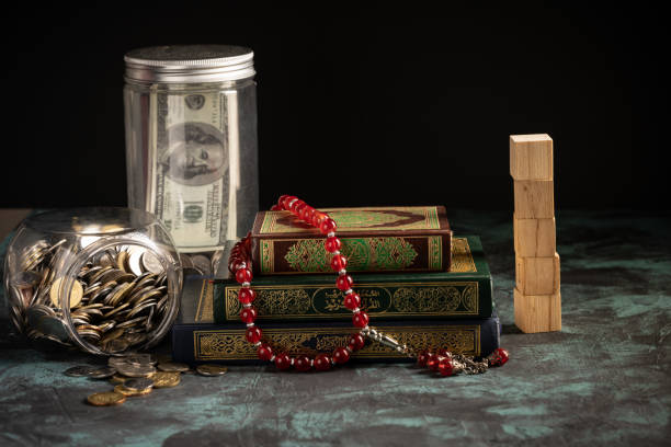 istock Islamic concept: The holy Quran and Tasbih (prayer beads beads) on dark background 1203115765