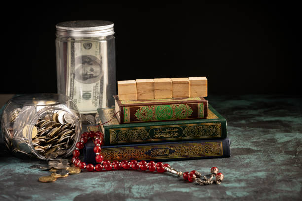 istock Islamic concept: The holy Quran and Tasbih (prayer beads beads) on dark background 1203115780