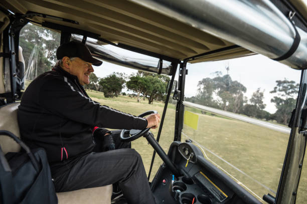 istock man driving the golf car 1203116974