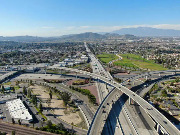 Aerial view of highway transportation with small traffic, highway interchange and junction, Riverside, California, USA