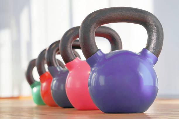 istock Colorful kettlebells in gym 1203119701