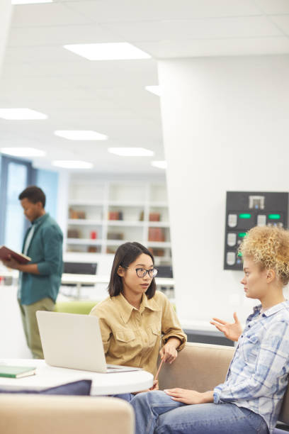 istock Two Young Women in Library 1203119934