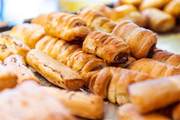 French pastry with ground beef filling on a tray with cumin glazed bagels