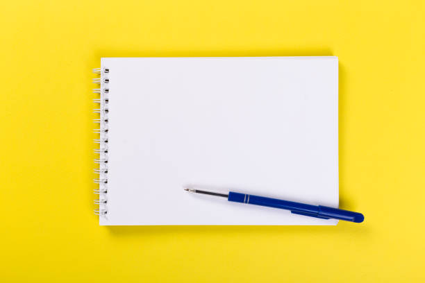 istock Sketchbook on colorful background. Copy space. top view of blank open notebook, concept of education or new workplace 1203121841