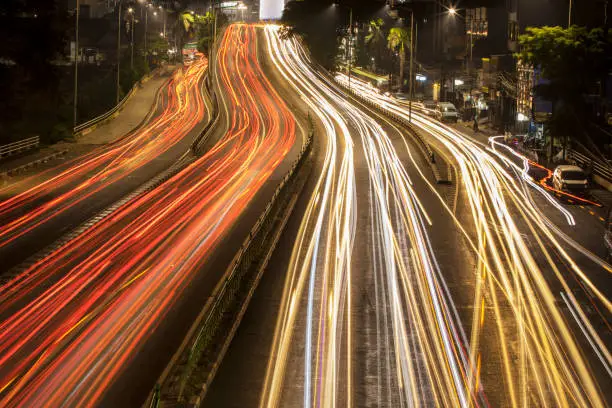 JAKARTA - Indonesia. August 27, 2019: Light trails of vehicle on the main road at night on Central Jakarta, Indonesia