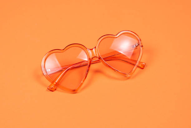 istock Summer hat lay on pink hair on orange background. 1203122385