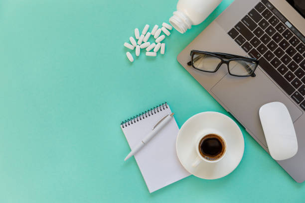 istock Doctor desk table with stethoscope and laptop computer. Top view with copy space, flat lay. 1203124133