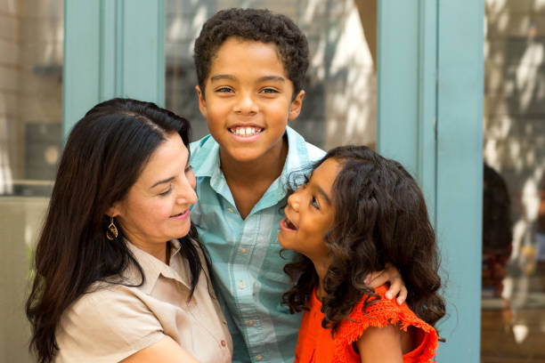istock Hispnaic mother laughing and talking with her children. 1203124229