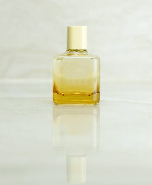 istock Glass bottle with perfume on beige background 1203124684