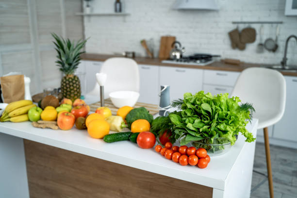 istock Healthy food, fruit, vegetable, berries , leaf vegetable on a table in a kitchen background. 1203126640