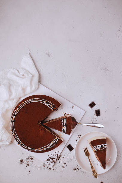istock Cold Chocolate Cheese Cake and a slice of cake. Top View 1203126668