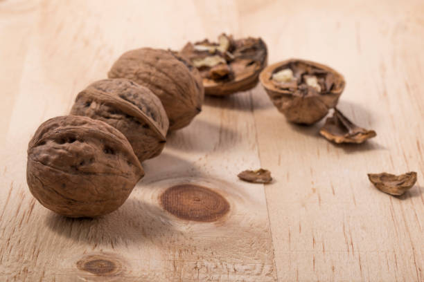 istock Walnuts isolated on wooden background. 1203126735