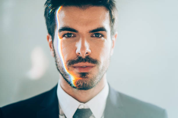 Artificial Intelligence Portrait of a handsome young man with spectrum of light on his face. prism photos stock pictures, royalty-free photos & images