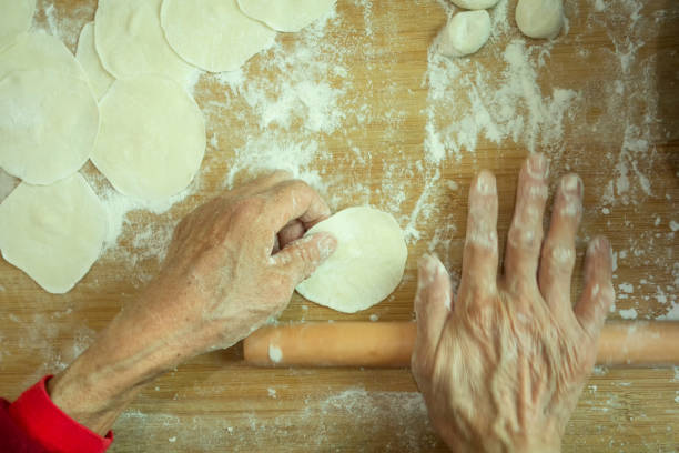 istock The old man's hand is making dumplings 1203129805