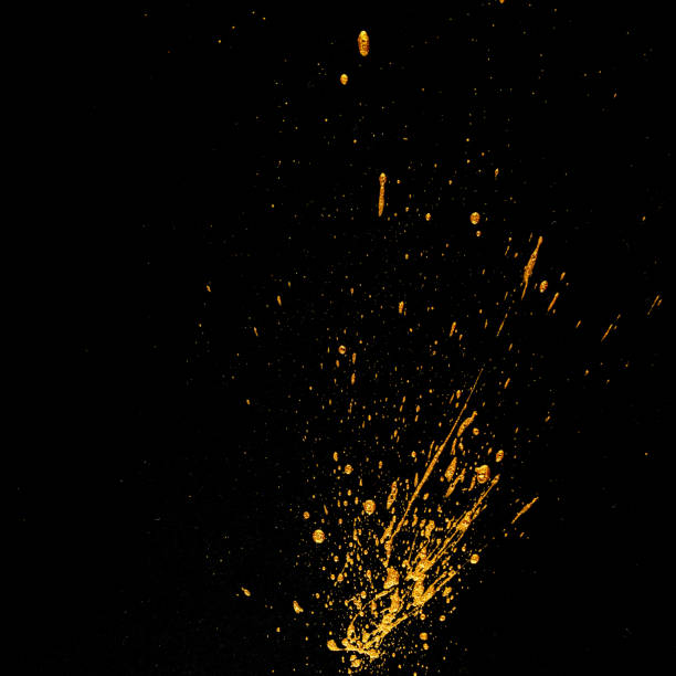 istock Golden dots of paint on a black background. 1203131150