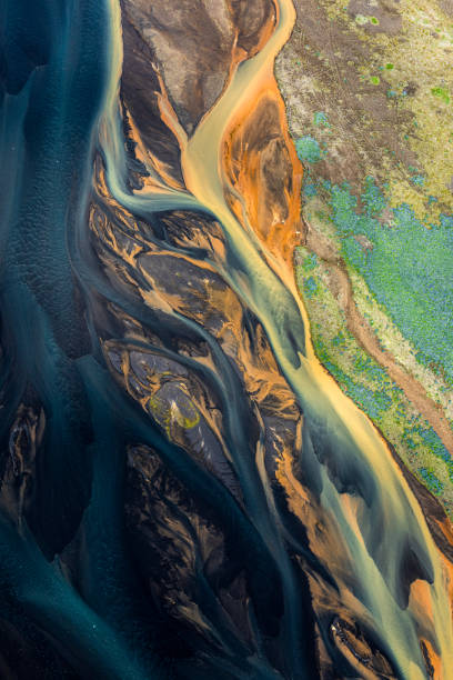 A flowing landscape of Icelandic glacial rivers A dream-like landscape of Iceland, with flowing glacial rivers, taken from a helicopter. grand river stock pictures, royalty-free photos & images