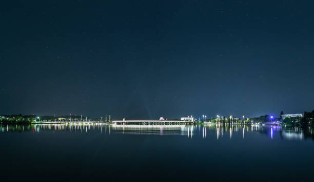 View of Commonwealth Bridge at night looking over Lake Burley Griffin in Canberra, the capital city of Australia stock photo