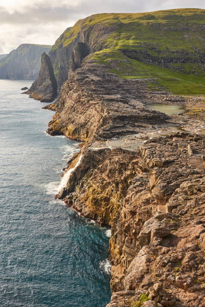 istock Faroe islands dramatic coastline viewed from helicopter. Vagar flight 1203134421