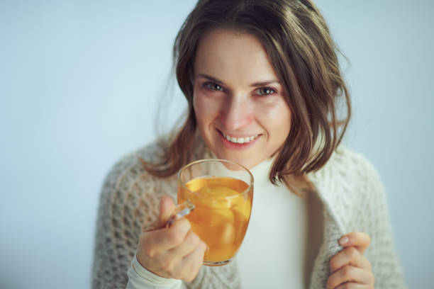 istock happy sick modern woman drinking cup of tea 1203134636
