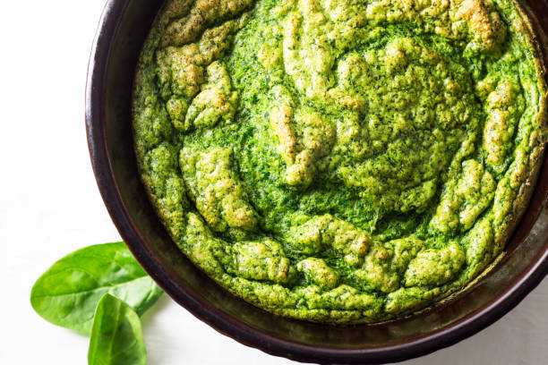 istock Baked spinach souffle in casserole dish close up overhead photo 1203134718