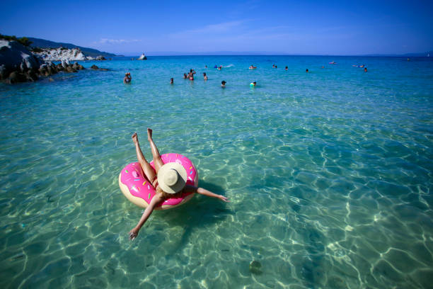 istock Woman floating on an air mattress 1203134856