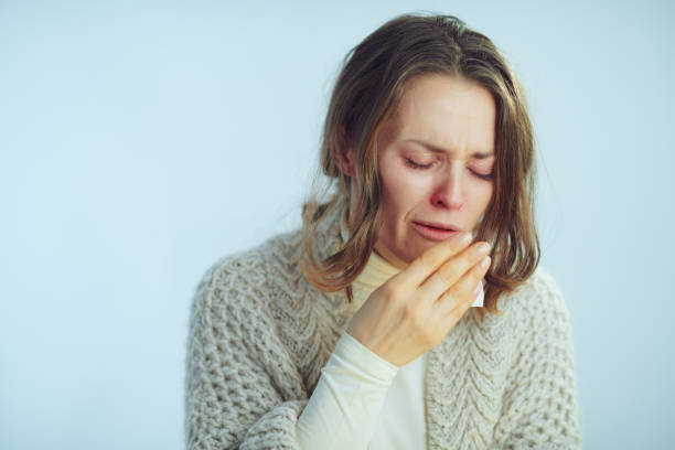 istock ill elegant woman with napkin coughing 1203134862
