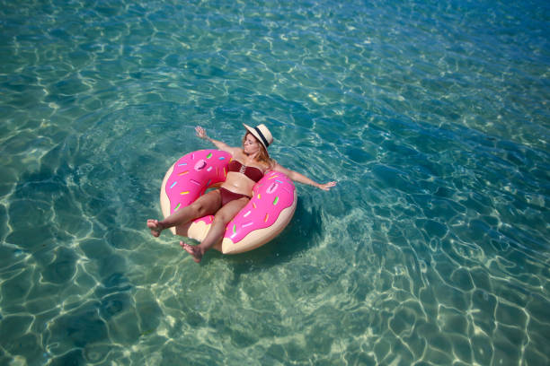 istock Woman in an inflatable donut ring 1203134947