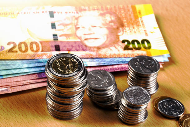 istock Stacks of shiny South African coins plus some banknotes 1203135665