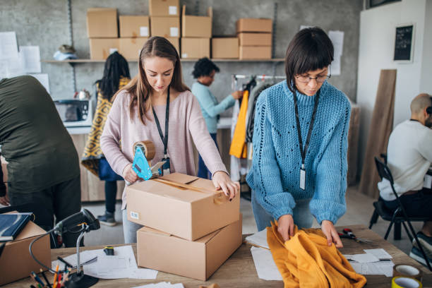 istock Diverse group of people arranging customers orders for drop shipping 1203135803