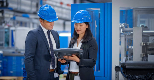 istock Manager and engineer discussing in factory 1203135826