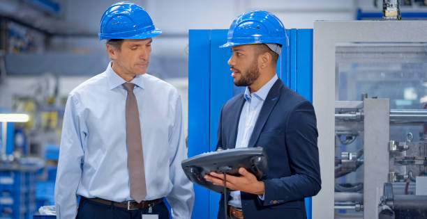 istock Engineer and supervisor discussing in factory 1203135837