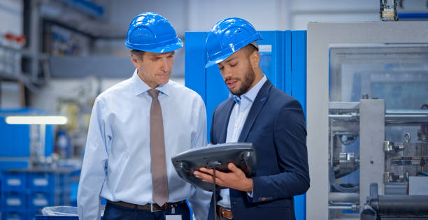 Engineer and supervisor discussing in factory