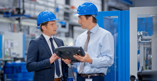 istock Manager and engineer discussing in factory 1203135841