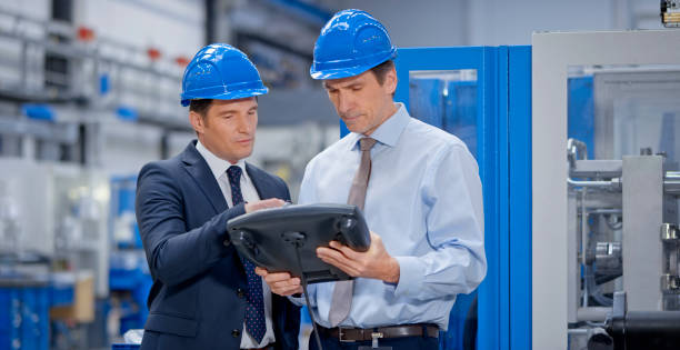 istock Manager and engineer discussing in factory 1203135843