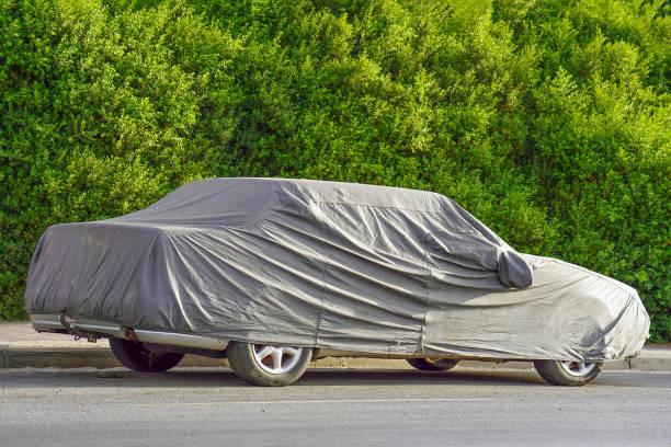 istock A parked car with protective cover in sun weather 1203137548